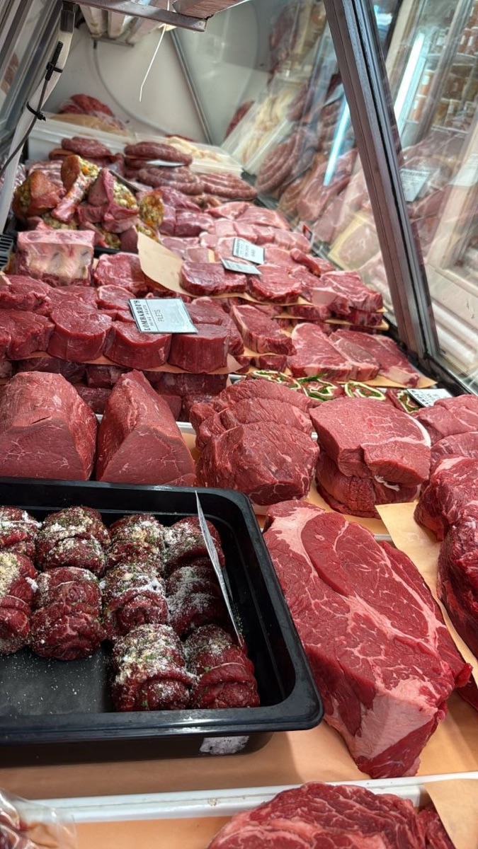 Lombardi's Prime Meats refrigerated case filled with fresh hand-cut meats